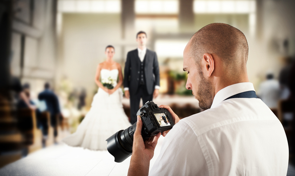 Image Showing A Close-Up View Of A Man Staring an image in his camera During Wedding Function