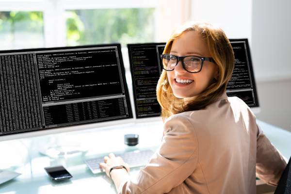 A Woman Programmer Coding On Computer.